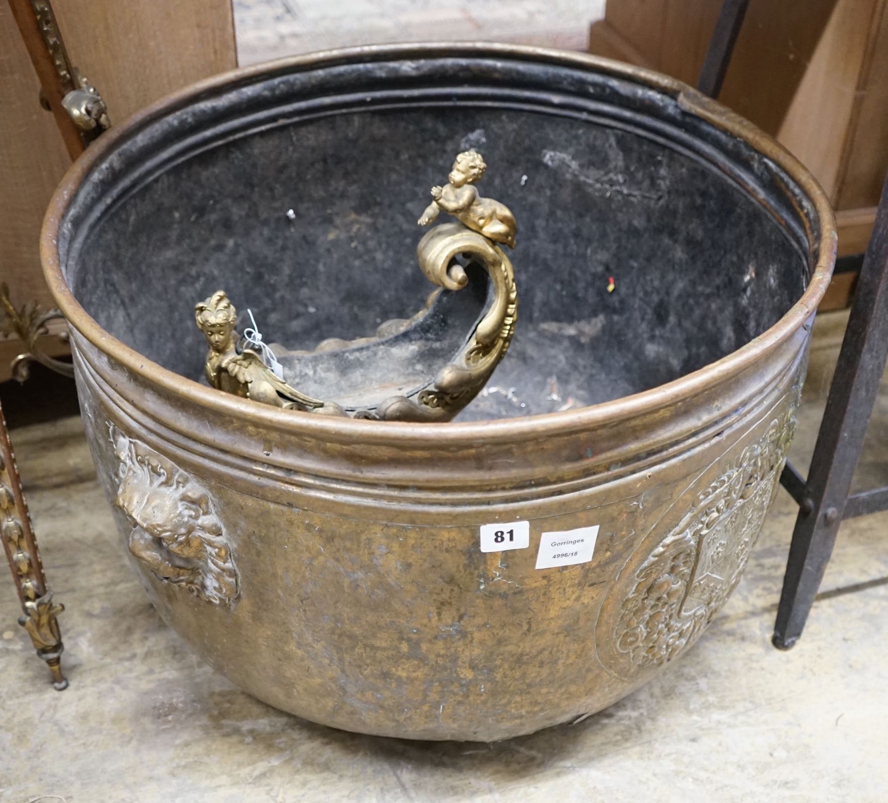 A large Dutch embossed brass circular log bin, diameter 63cm together with a gilt metal cornucopia centrepiece